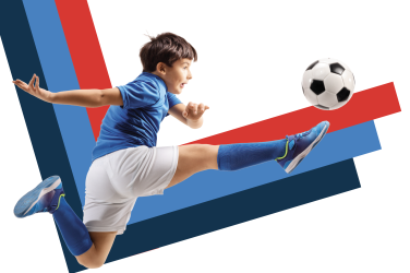young boy in soccer uniform kicking a football (futbol) on a striped background